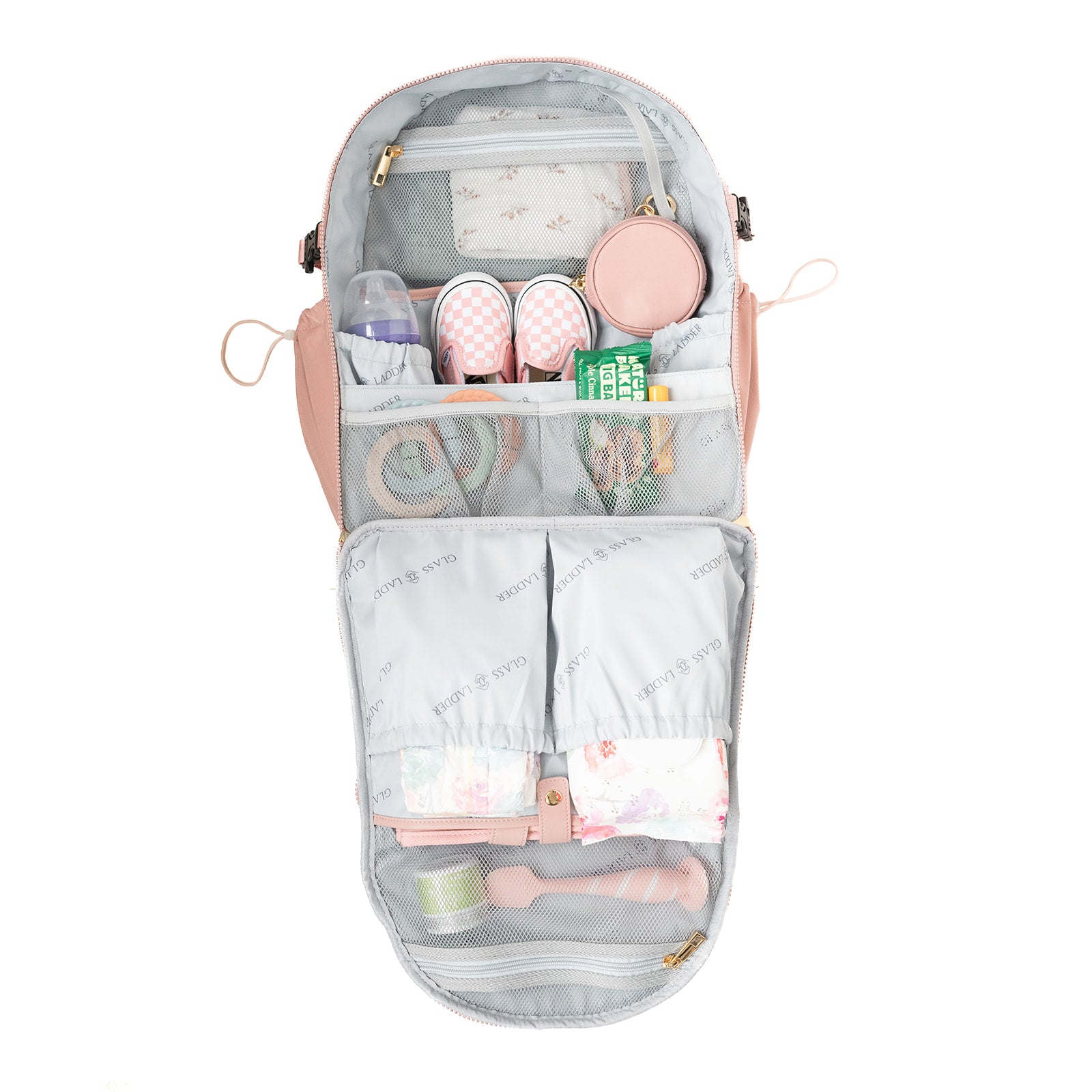 The Amanda Backpack by Glass Ladder in Pink Mimosa features organized compartments for baby essentials like bottles, diapers, wipes, shoes, a pacifier, cream, and a small bag. It has a light blue branded interior. Dimensions: L 12 x W 6 x H 15. Available for pre-order; ships early May.