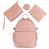 The Amanda Backpack in Pink Mimosa by Glass Ladder features matching accessories: a handbag, circular pouch, and foldable changing mat. Styled with gold-tone hardware and measuring L 12 x W 6 x H 15, it offers elegant functionality against a white backdrop. Pre-order now to ship early May.